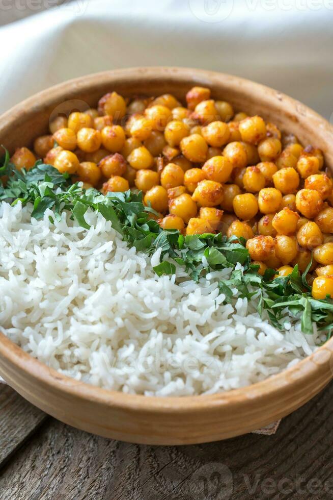Bowl of chickpea curry with white rice and fresh cilantro photo
