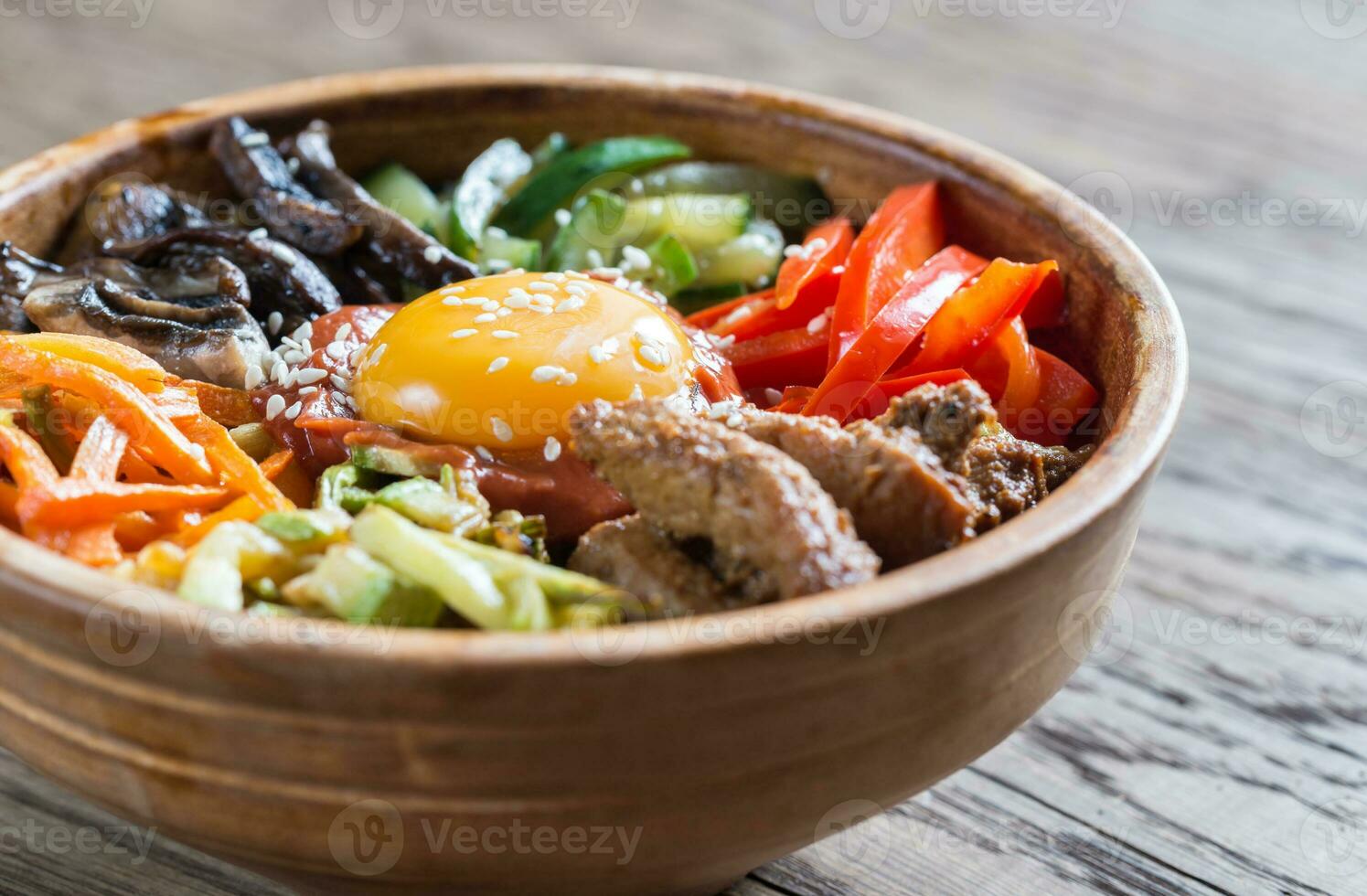 Bowl of bibimbap on the wooden table photo