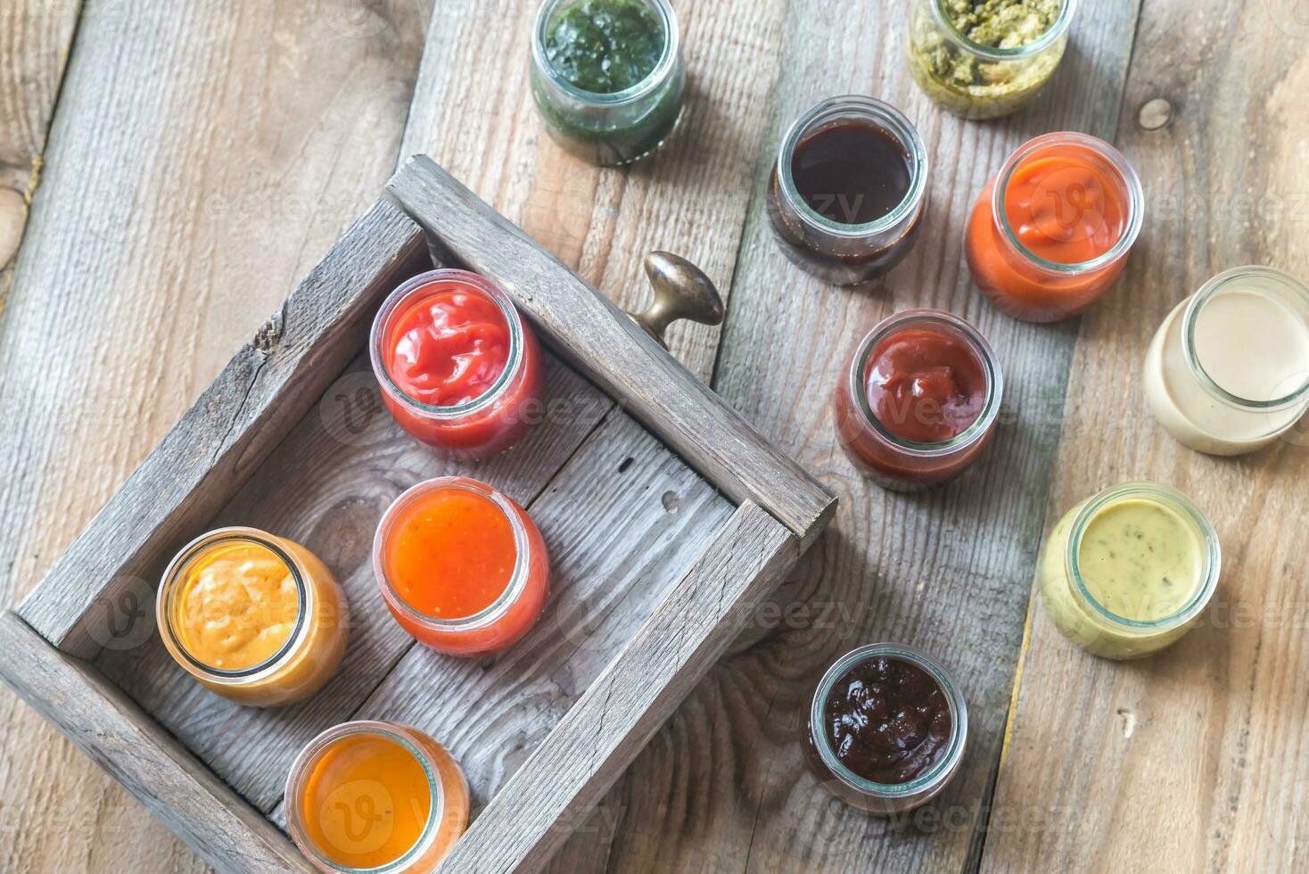 Assortment of sauces in the glass jars photo