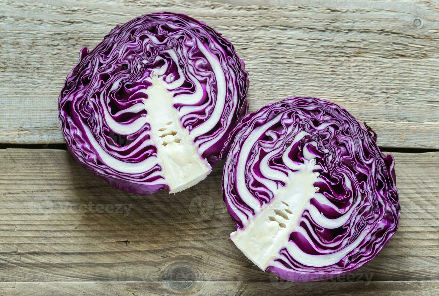 Two halves of red cabbage on the wooden background photo