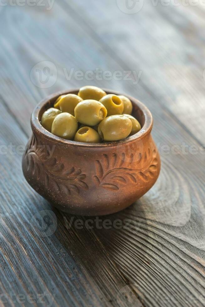 cuenco de aceitunas en el de madera mesa foto