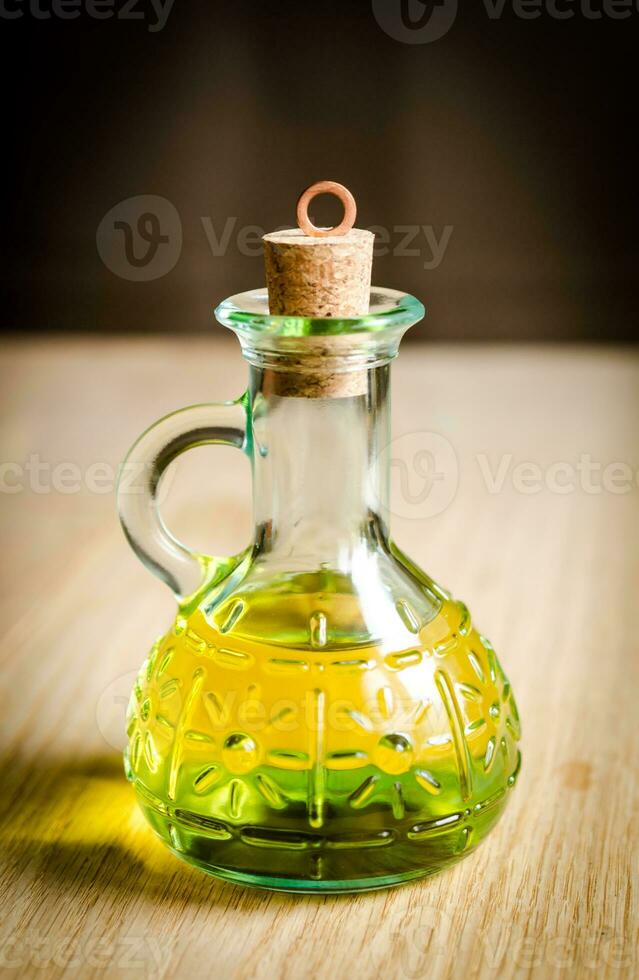 Small bottle of olive oil with cork stopper photo