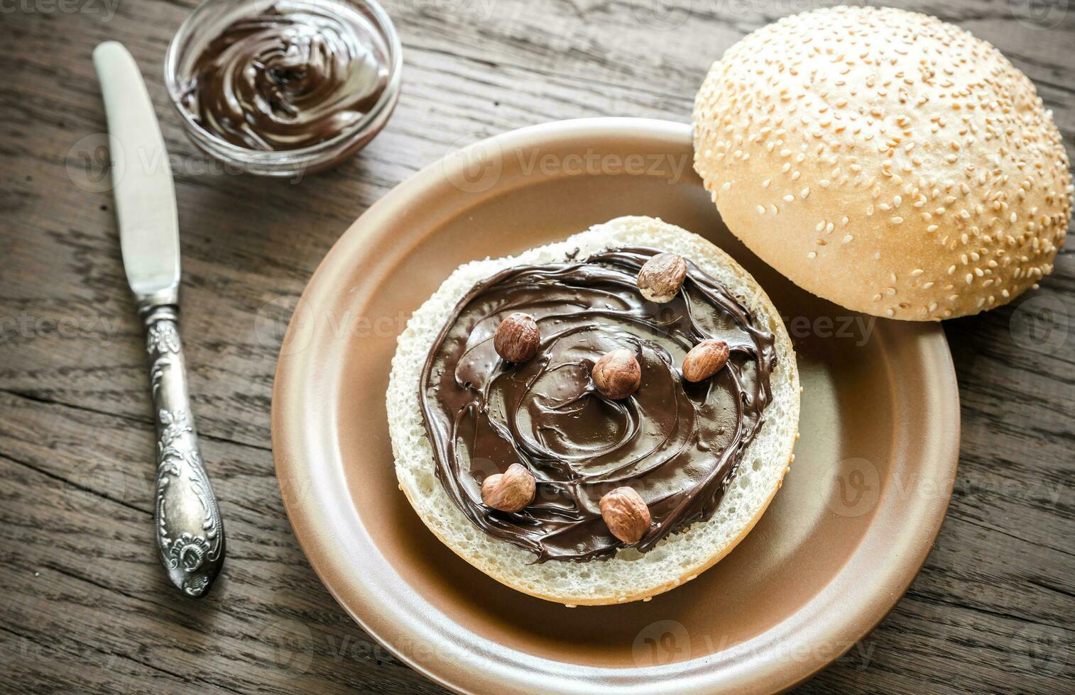 Seasame bun with chocolate cream and nuts photo