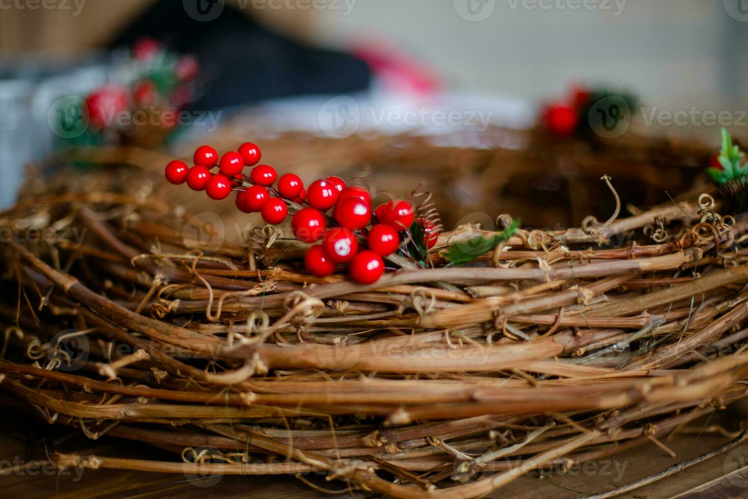 Christmas wreath with red berries on a wooden table. New Year's background. photo