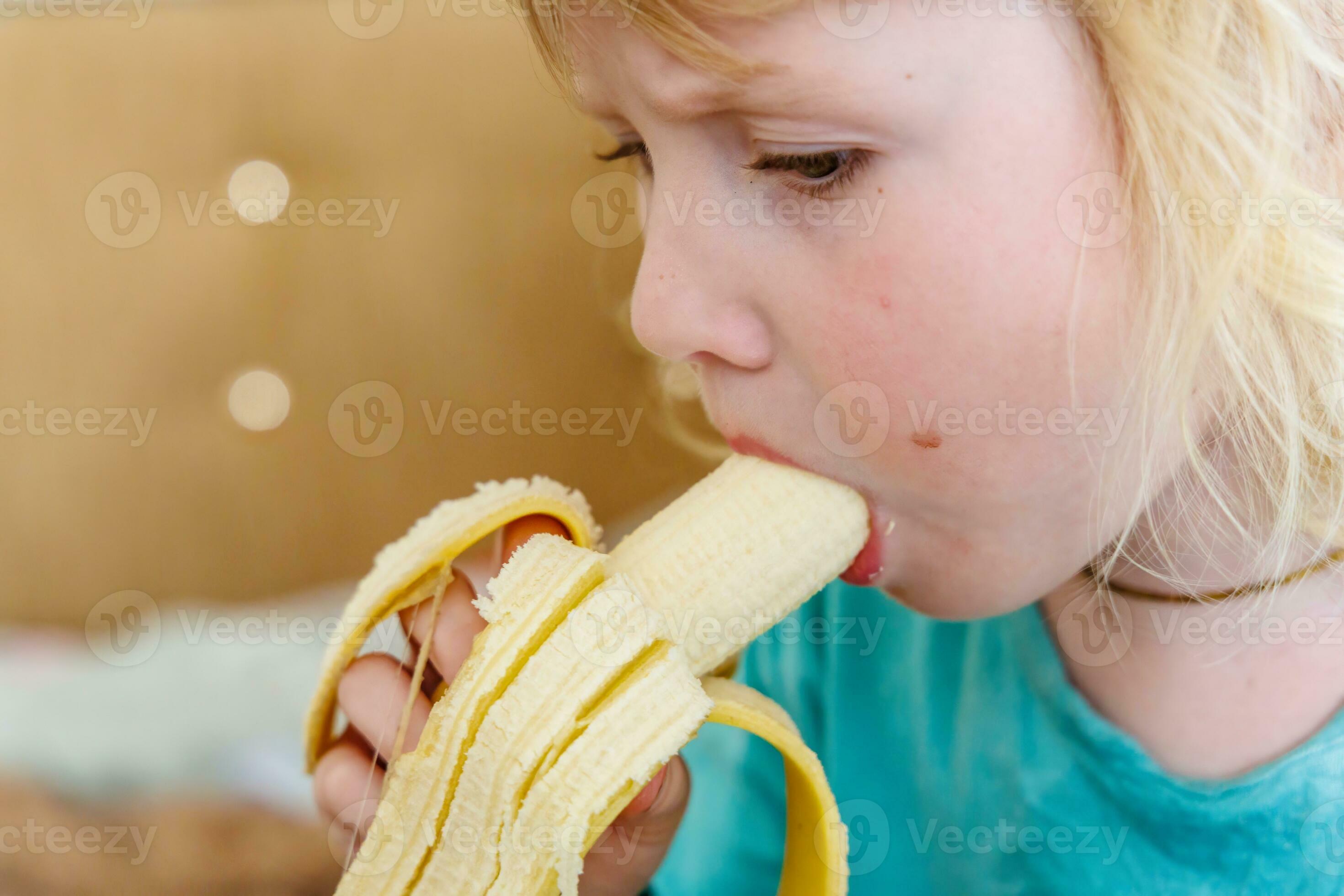 girl eating banana Portrait of a little girl eating a banana. The concept of healthy food. A  fresh quick snack 36329665 Stock Photo at Vecteezy