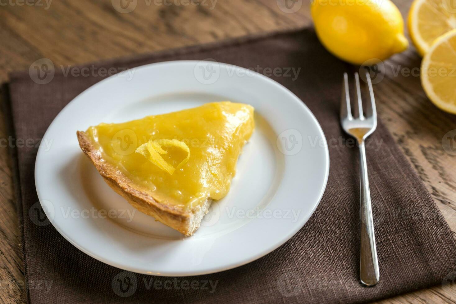 Slice of lemon tart on the plate photo