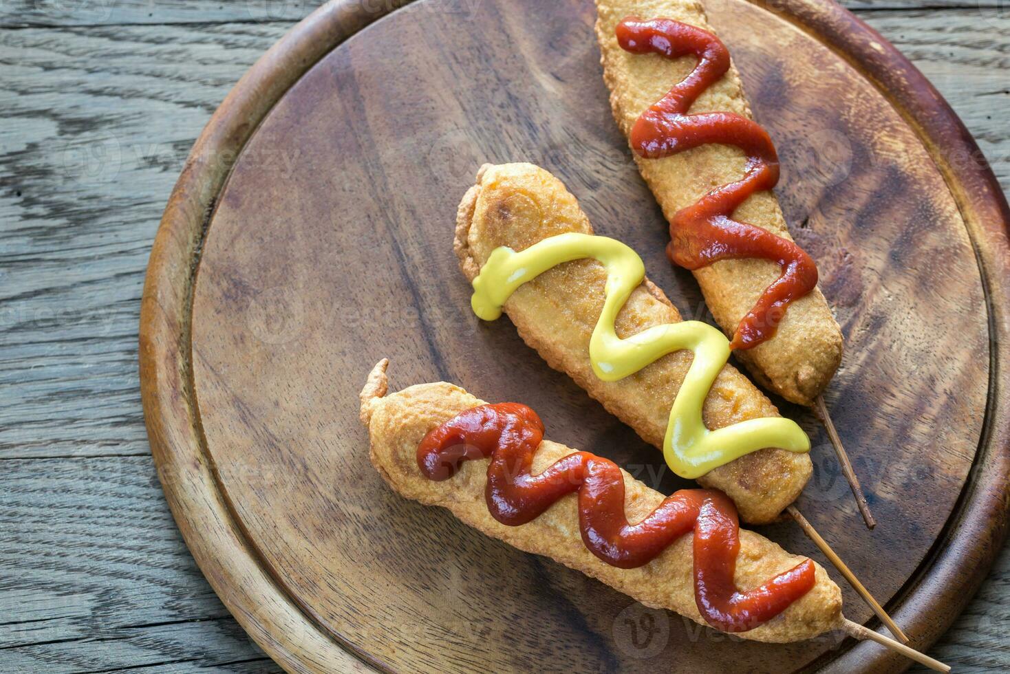 Corn dogs on the wooden board photo