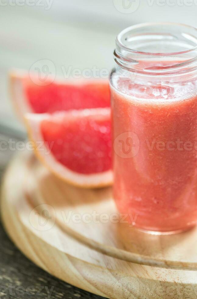 Glass jar of grapefruit smoothie photo