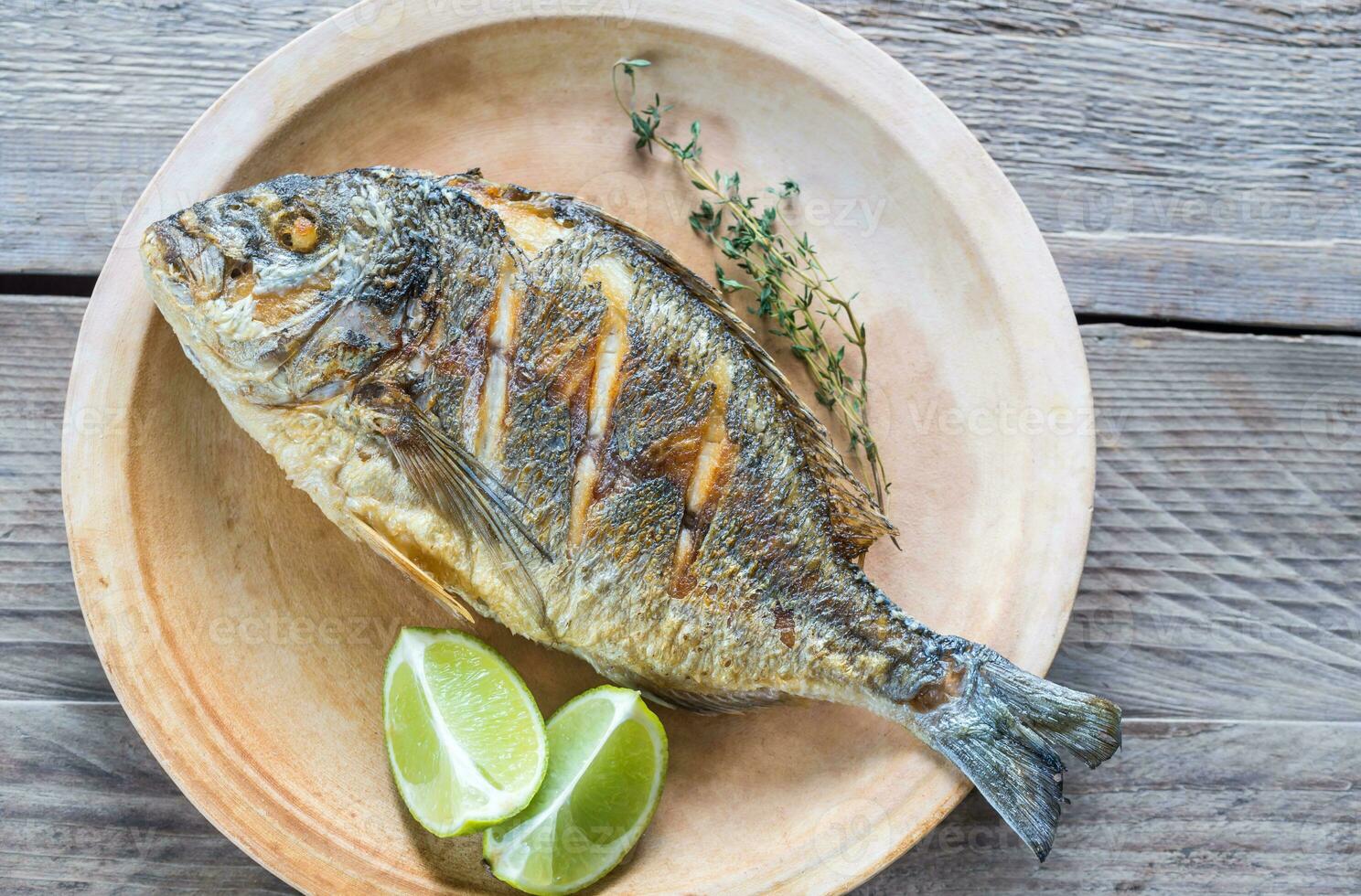 Grilled Dorade Royale Fish on the plate photo