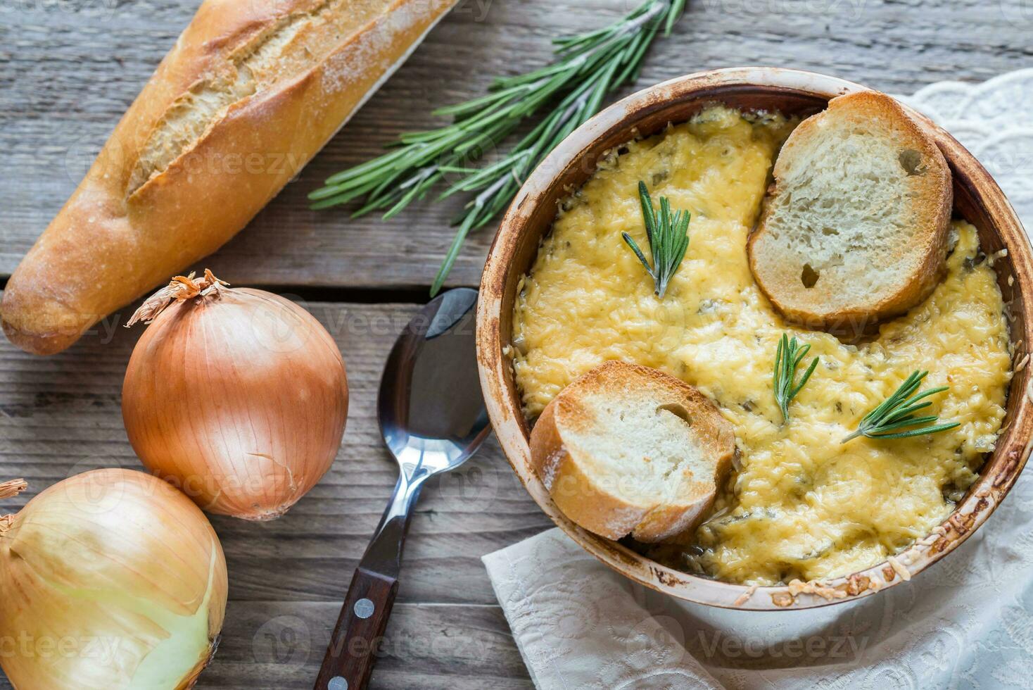 Bowl of onion soup on the wooden table photo