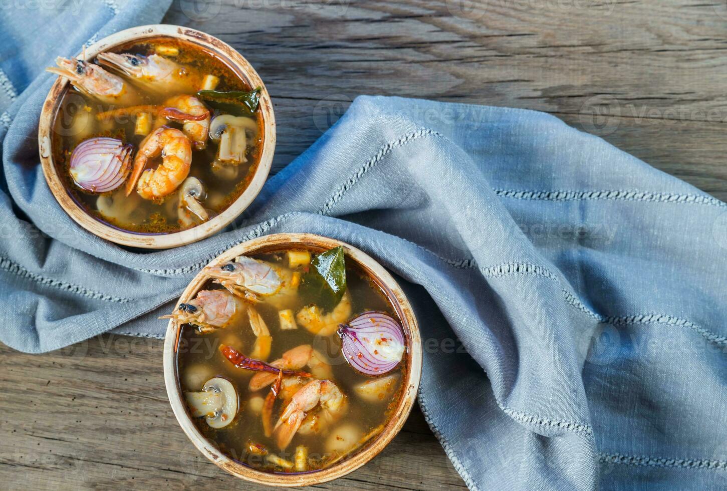 Two bowls of thai tom yum soup photo