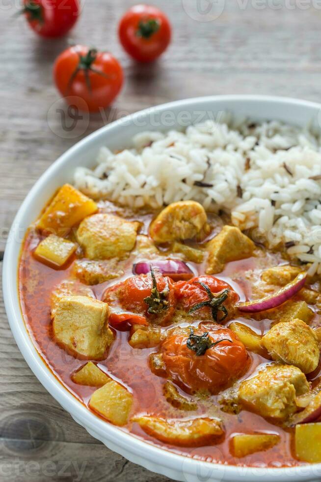 Thai yellow curry with chicken and rice photo