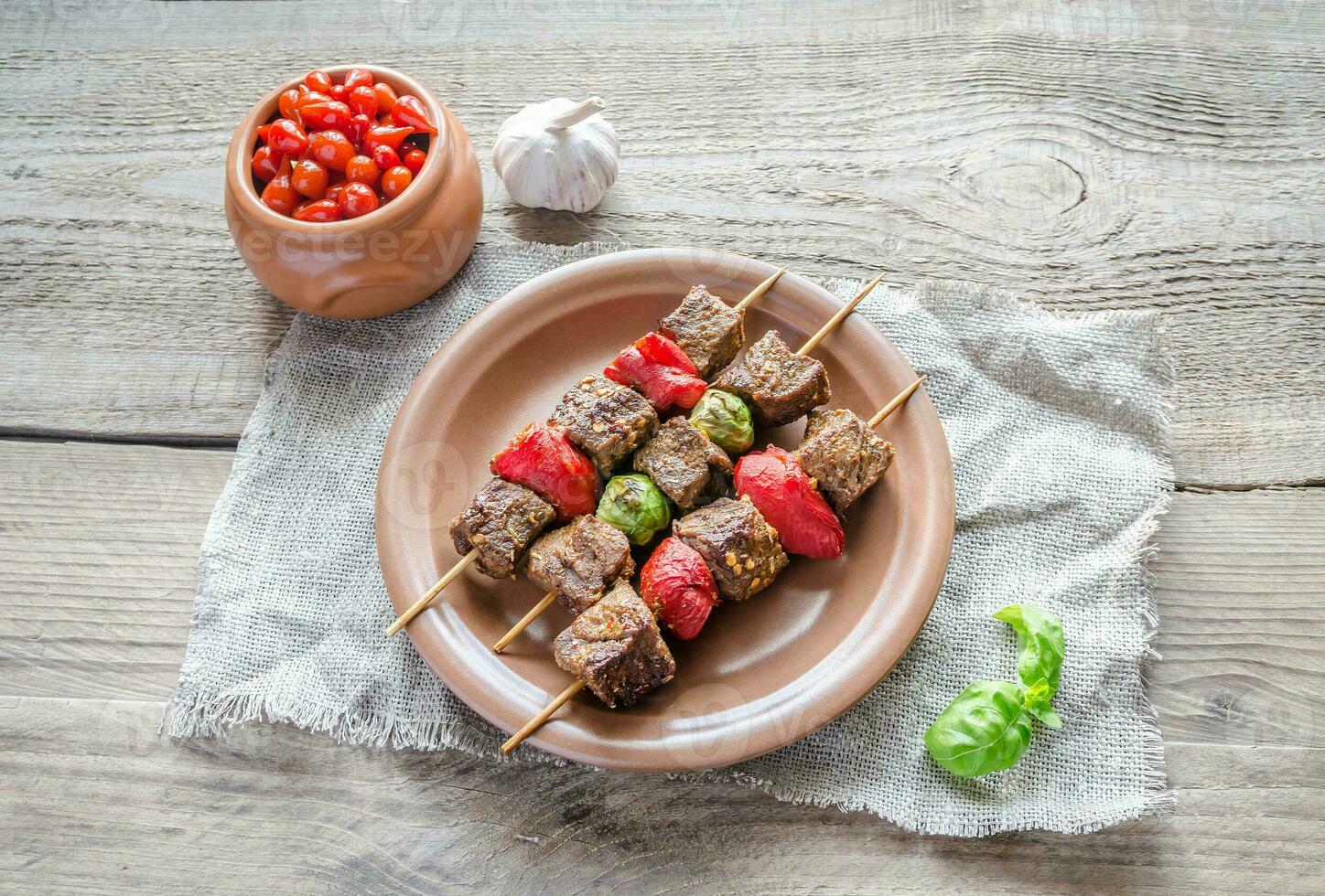 Grilled beef skewers with pepper and brussels photo