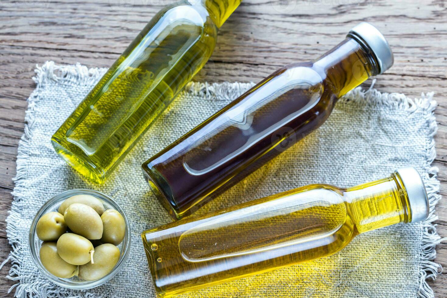 Bottles with different kinds of olive oil photo