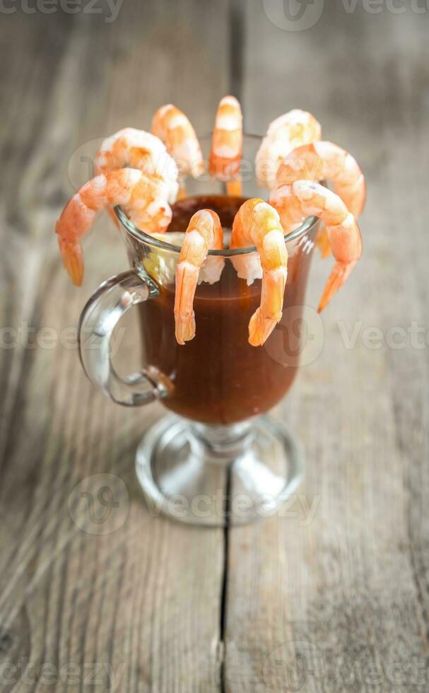 Cooked prawns  with tomato sauce on the wooden table photo