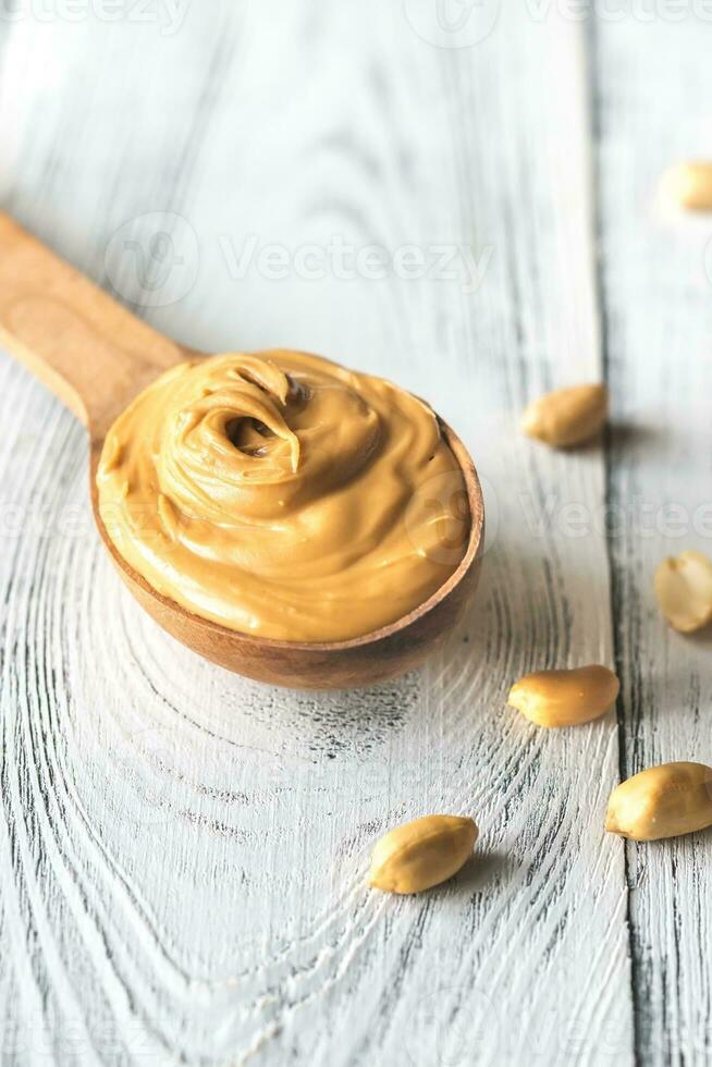 Wooden spoon of peanut butter photo