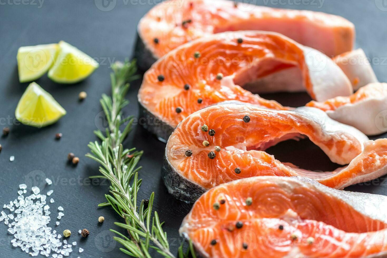 Raw trout steaks on the wooden board photo