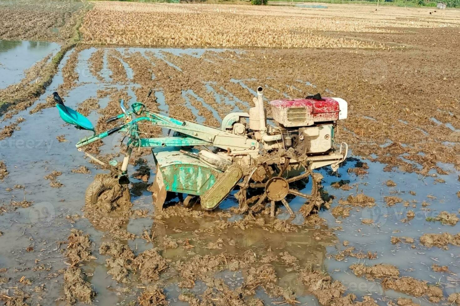 tractor or power tiller the field is plowed with modern farmer concept photo