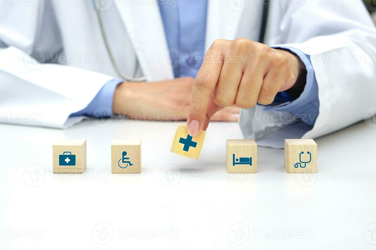Hand holding a wooden block cube with healthcare medical icon symbol. Medical and health concept. photo