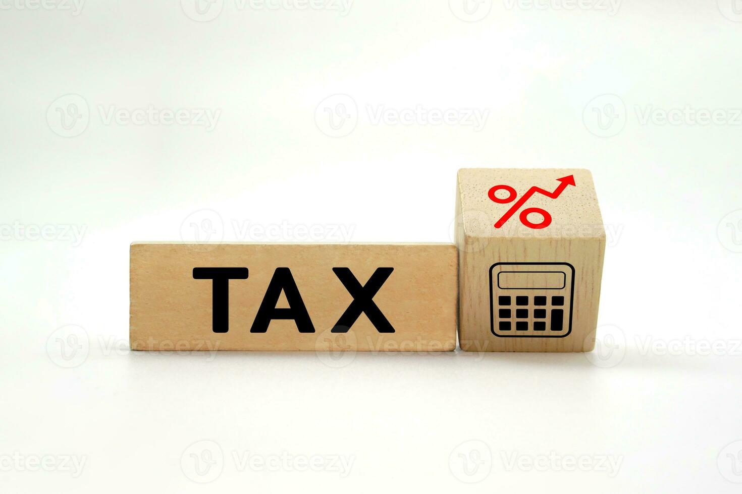 Wooden block with the word TAX and on the side there are icon rising percentage. Business, taxation, finance and tax burden concept. photo