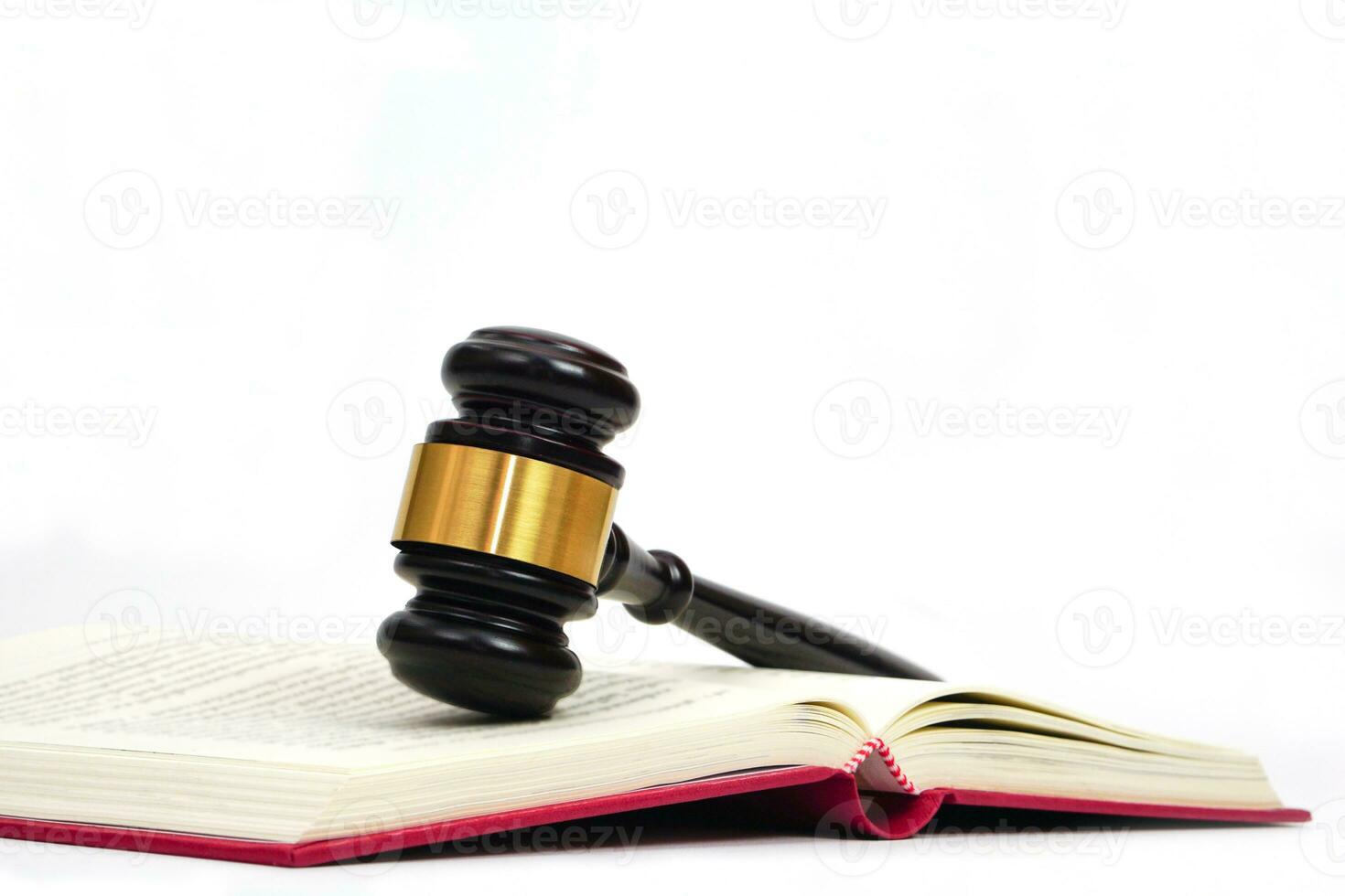 Close up of judge gavel on law book in white background. Lawyer, law, justice system, hammer auction. photo