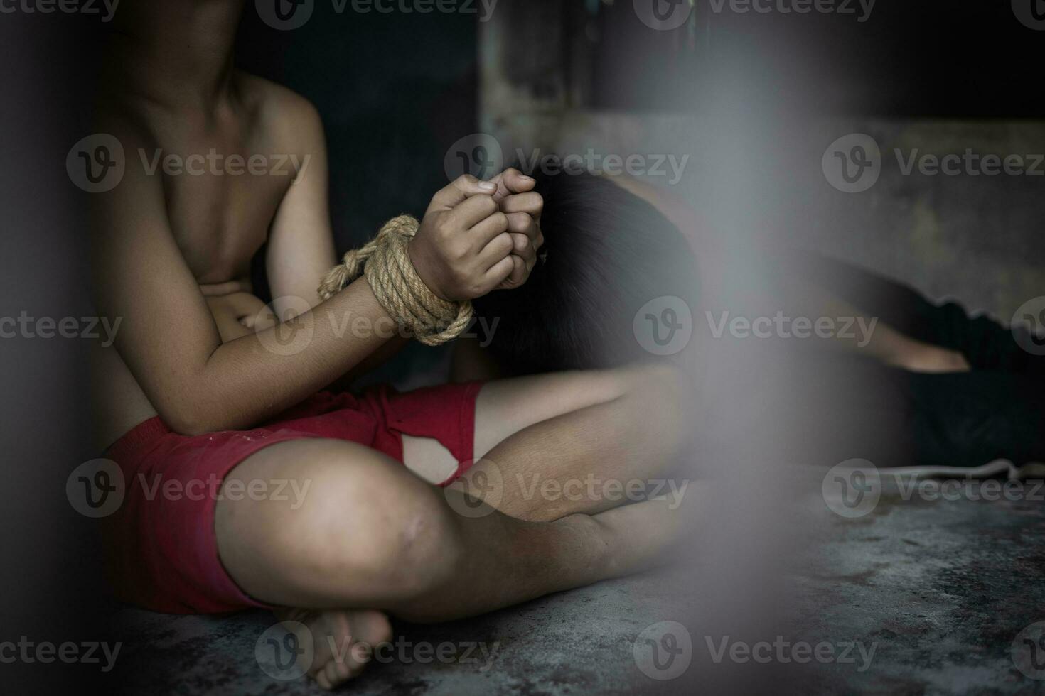 Hopeless man hands tied together with rope,  child labor concept, poor children victims of human trafficking process, poverty, child abuse. photo