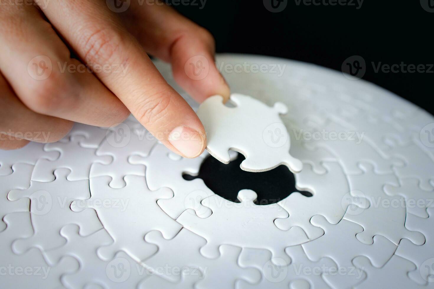 Hand put the last piece of jigsaw puzzle to complete the mission, Business solutions, success and strategy concept, The solution includes completing the mission. photo