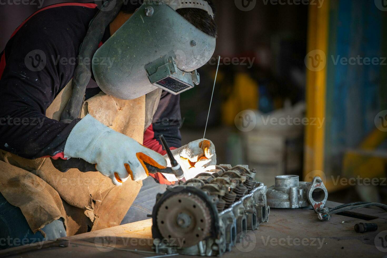 Welder is welding Tungsten Inert Gas welding, Welding aluminum with aluminum argon, TIG welding torch. photo