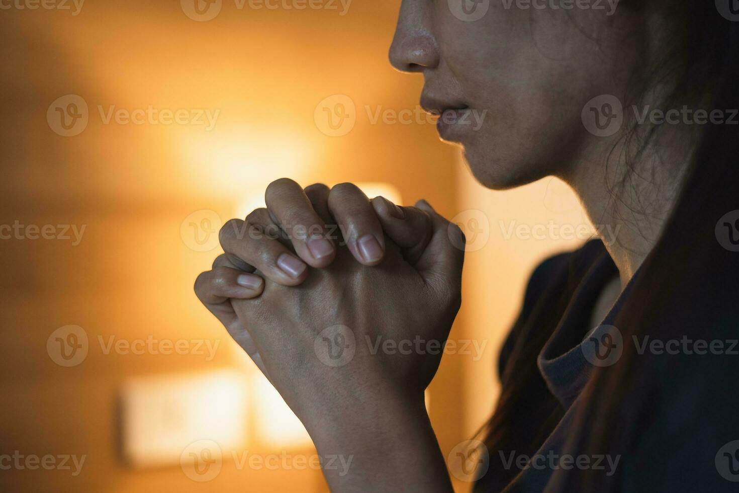 Christian woman praying in bedroom, woman hands praying to god, begging for forgiveness and believe in goodness. Christian life crisis prayer to god. Christian life crisis prayer to god. photo