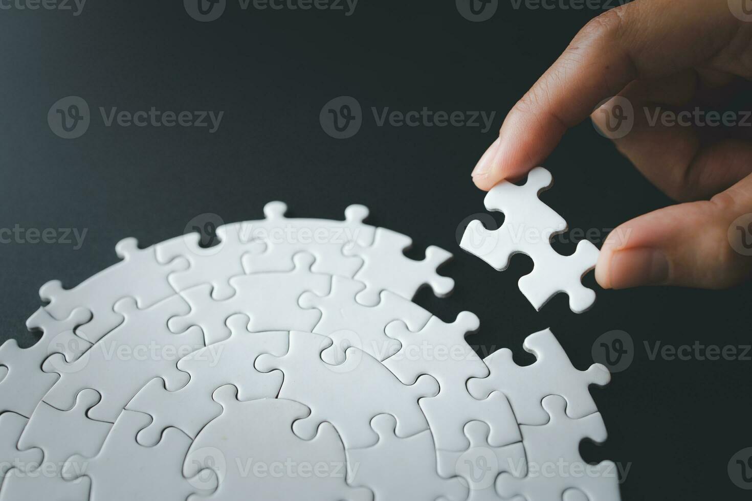 Hand put the last piece of jigsaw puzzle to complete the mission, Business solutions, success and strategy concept, The solution includes completing the mission. photo