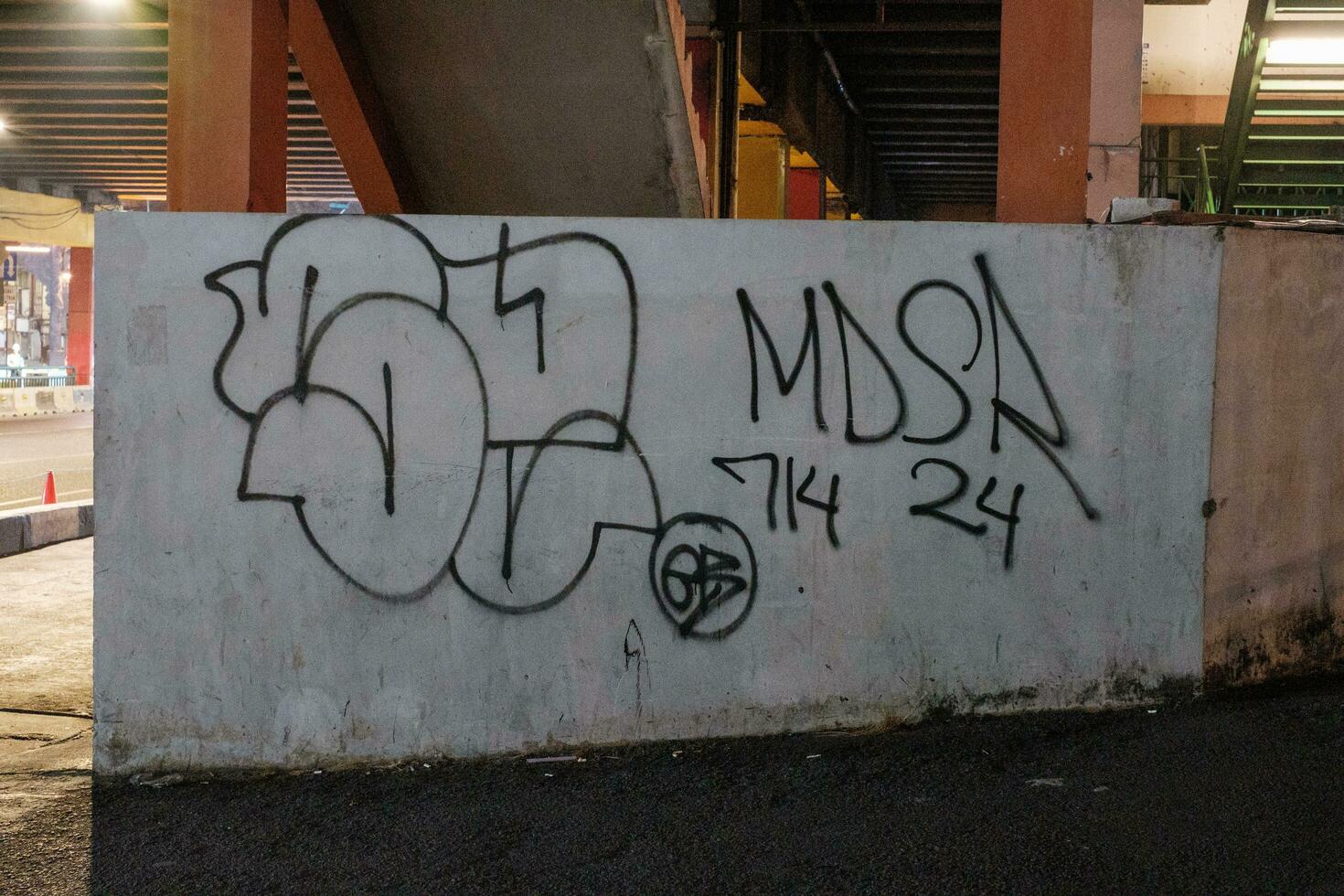 Jakarta, Indonesia - October 2 2023. Highway Wall with Graffiti Scribbles photo