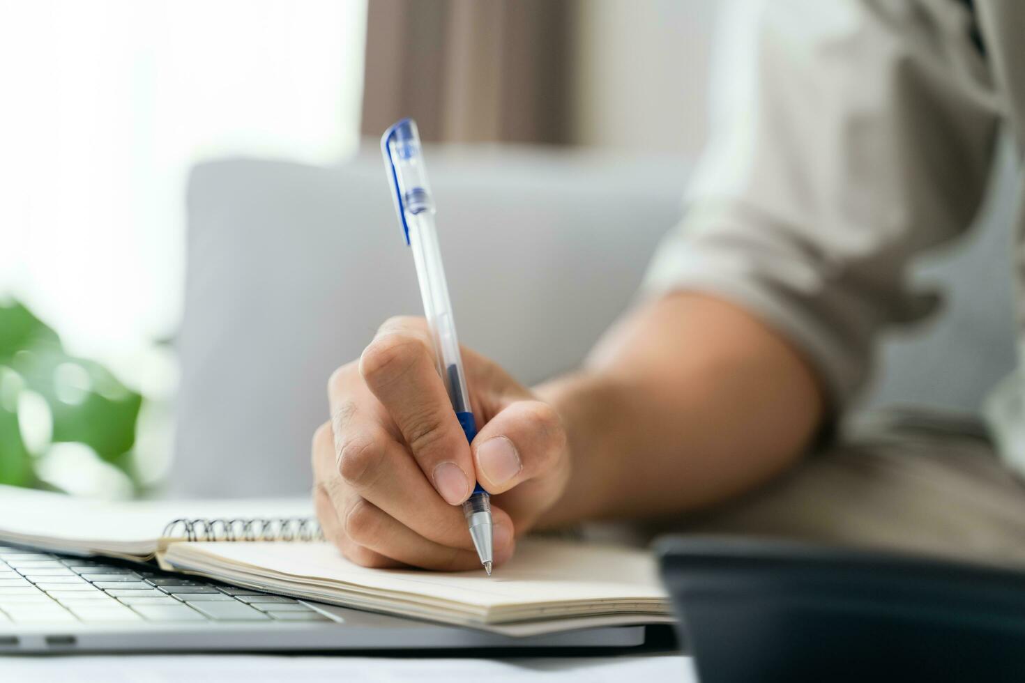 Man is calculating annual tax with calculator and filling form of Individual Income Tax Return. Season to pay Tax and Budget planning concept. photo