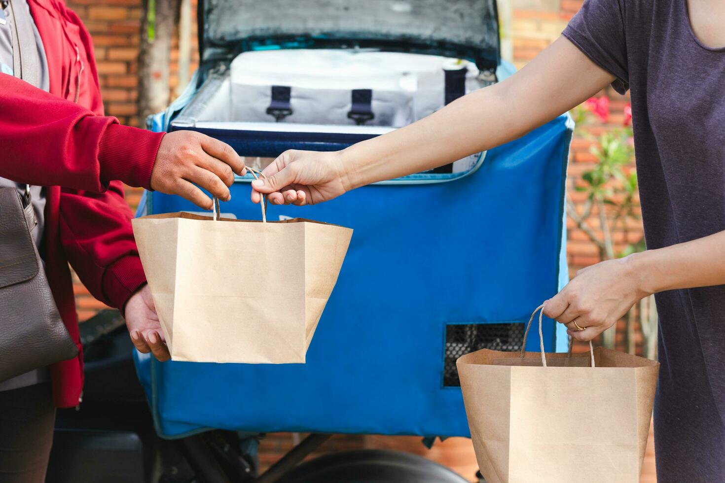 Female hand receiving package from delivery man. photo