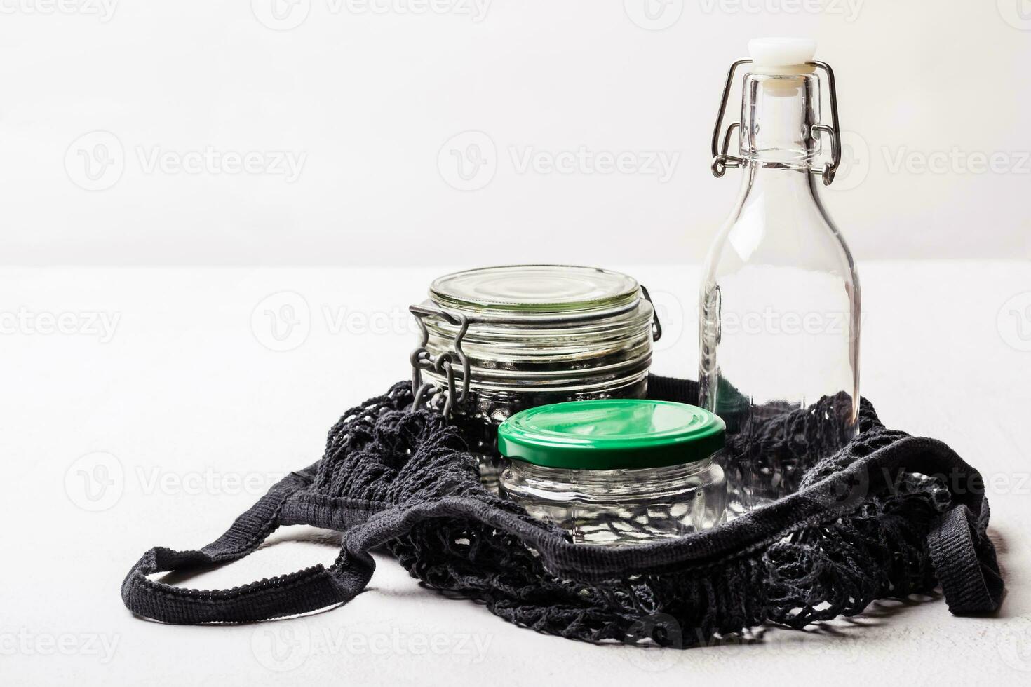 Glass Jars and bottle in cotton bag, selective focus photo