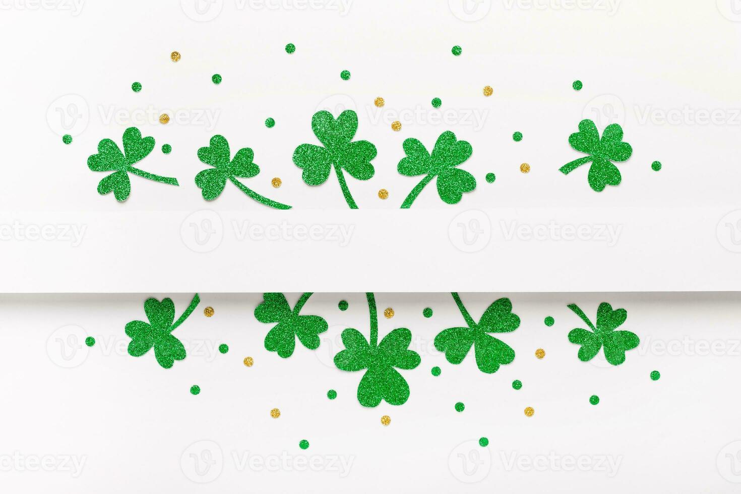 Green glitter shamrocks pattern on white background. Happy St. Patricks Day background photo