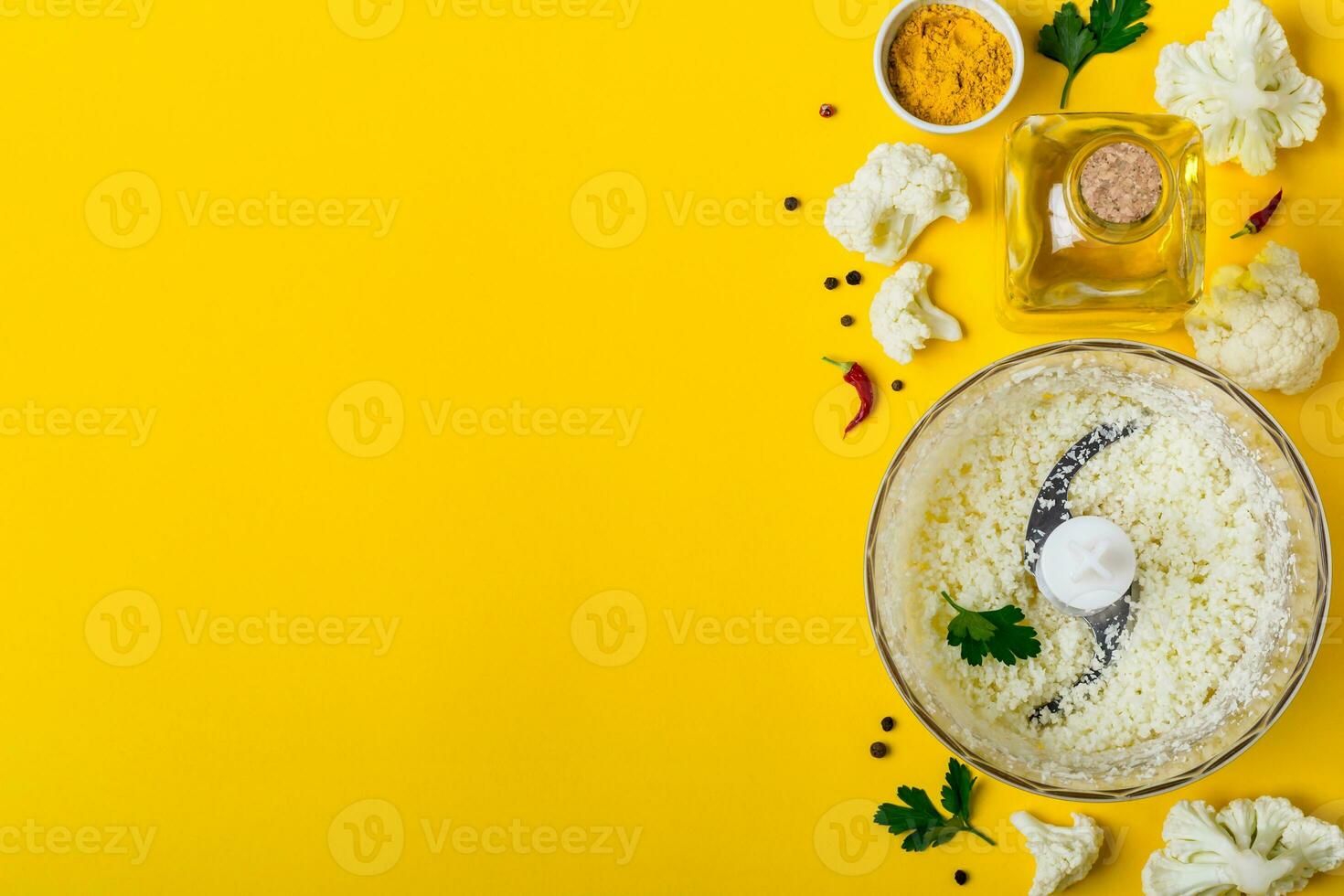 Blender bowl with cauliflower rice and spices. Healthy food background photo