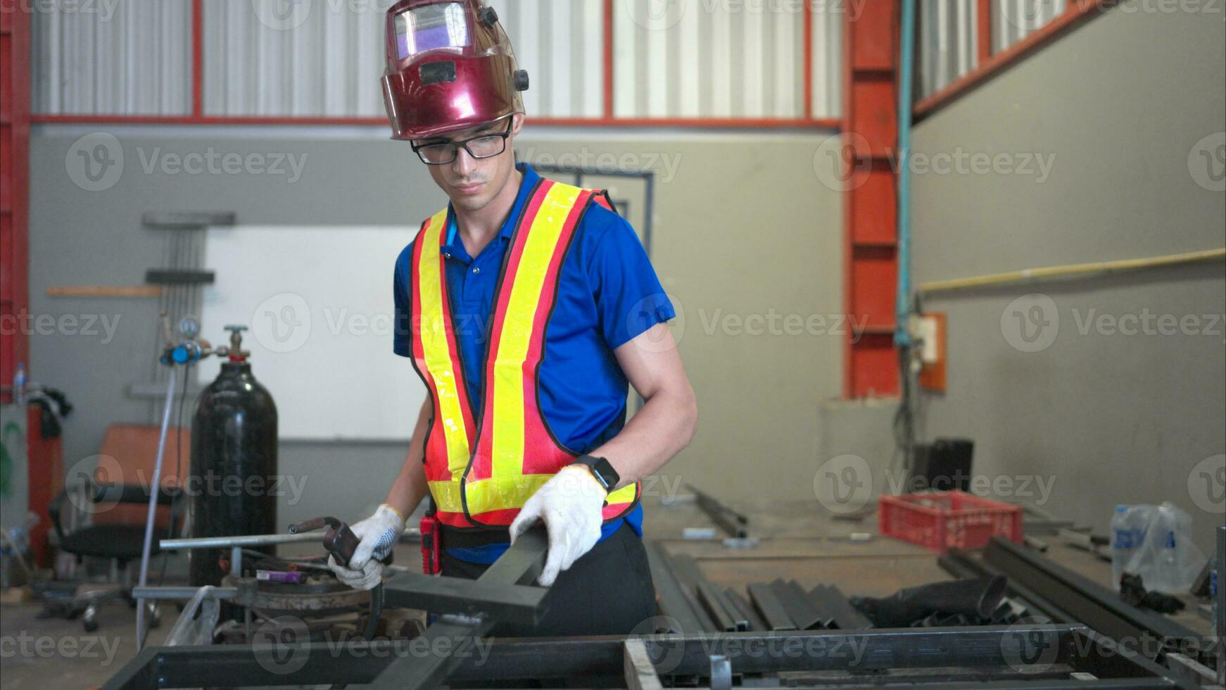 Warehouse worker wear hard hats to protect from welding glare, Welding steel parts of a building structure in a factory photo