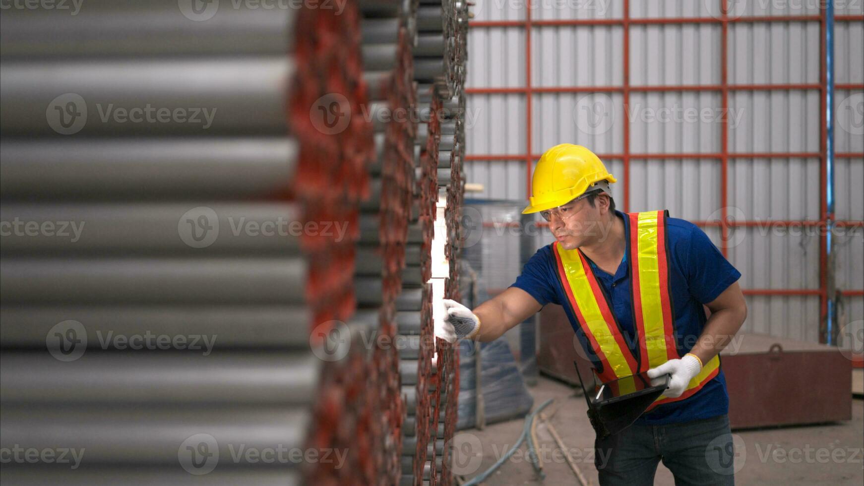 Warehouse worker in hard hats and helmets, Inspect and count steel in the warehouse. photo