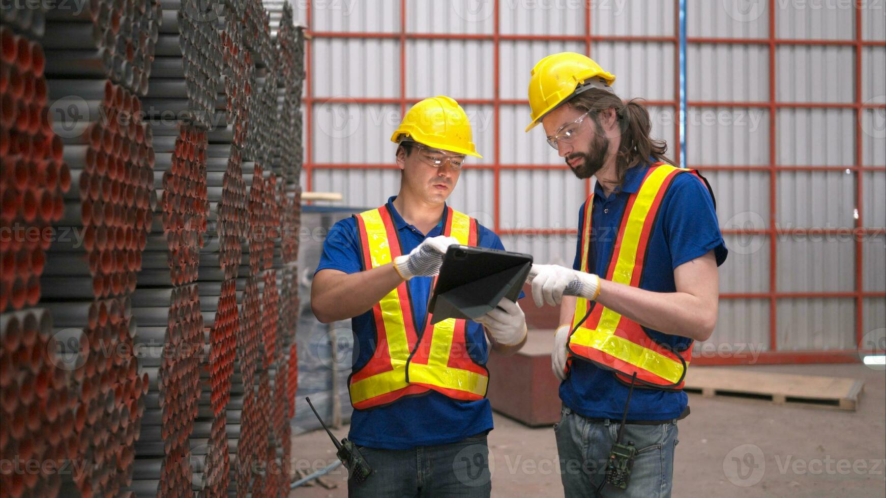 Warehouse workers in hard hats and helmets, Inspect and count steel in