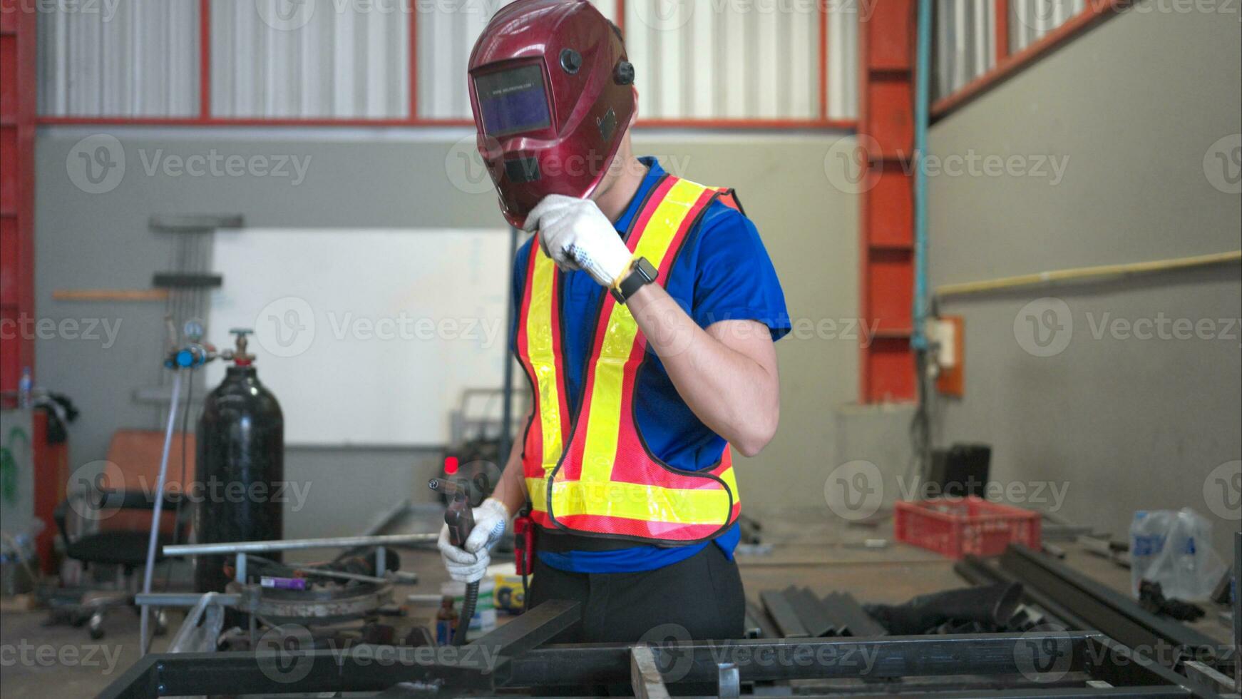 Warehouse worker wear hard hats to protect from welding glare, Welding steel parts of a building structure in a factory photo