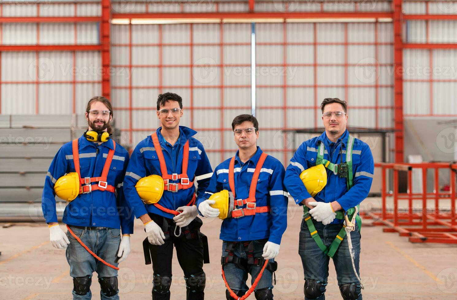 Portrait of a team of industrial workers standing together in a warehouse photo