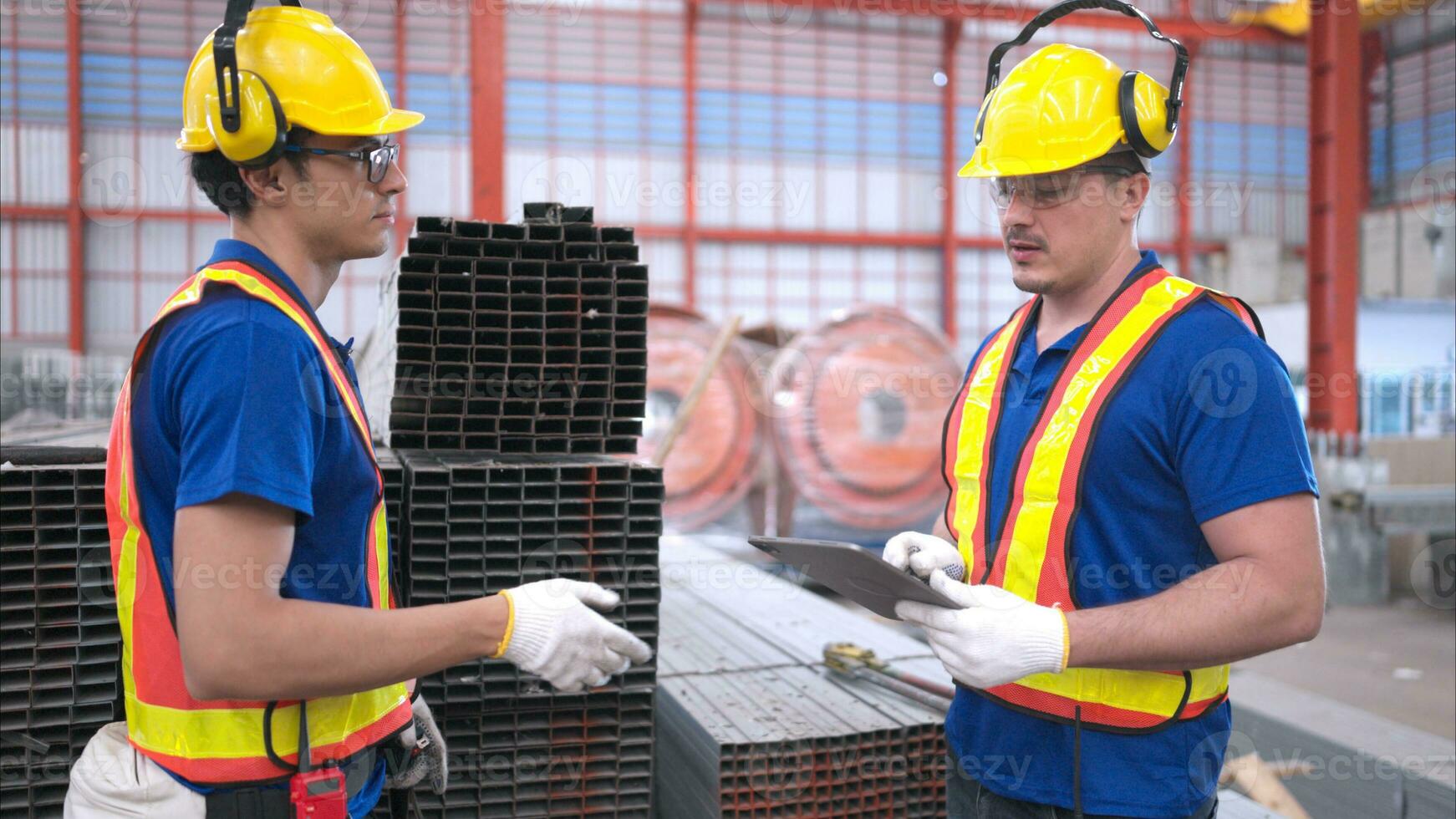 Warehouse workers in hard hats and helmets, Inspect and count steel in the warehouse. photo