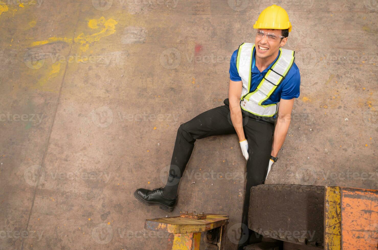 Young man working in a steel industry factory. He was critically hurt when a forklift ran over his leg and had to be transported to the hospital. photo