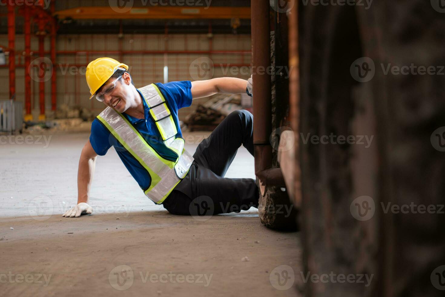 Young man working in a steel industry factory. He was critically hurt when a forklift ran over his leg and had to be transported to the hospital. photo