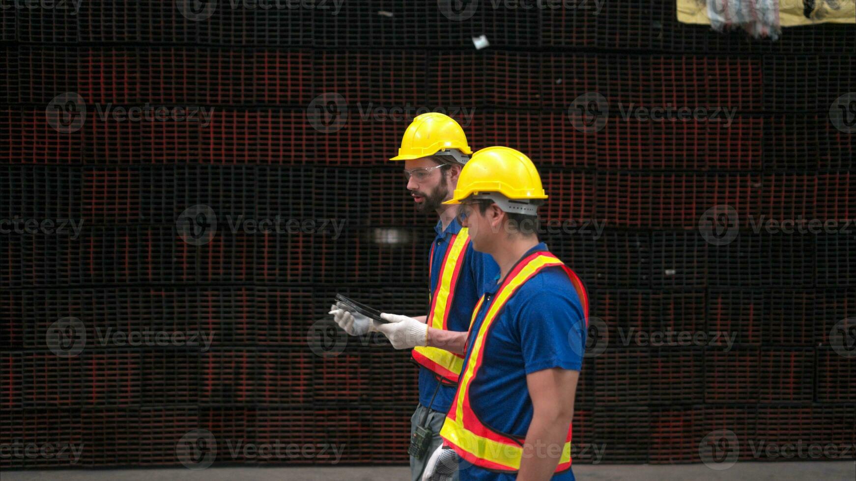 Warehouse workers in hard hats and helmets, Inspect and count steel in the warehouse. photo