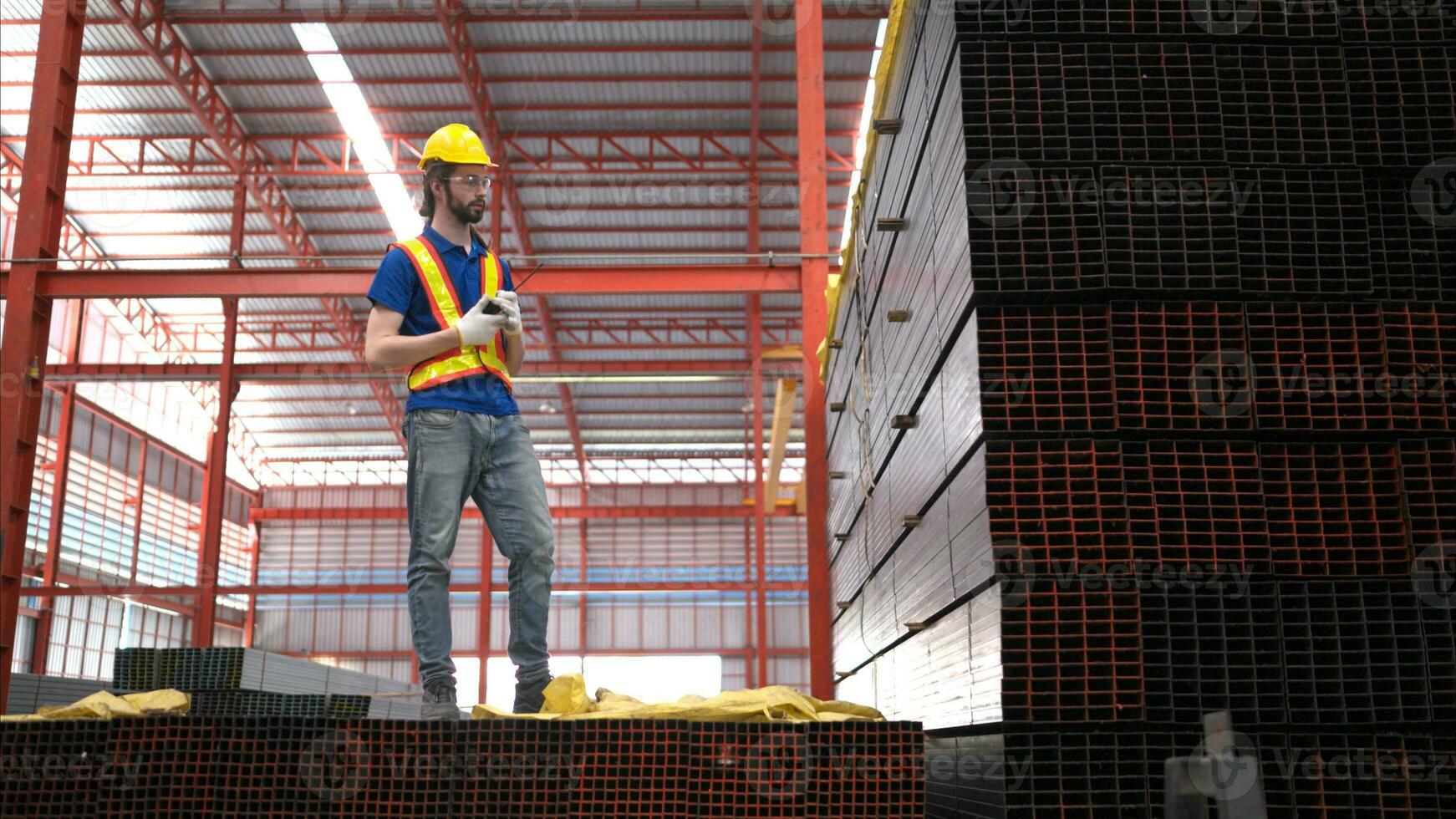 Warehouse worker in hard hats and helmets, Inspect and count steel in the warehouse. photo