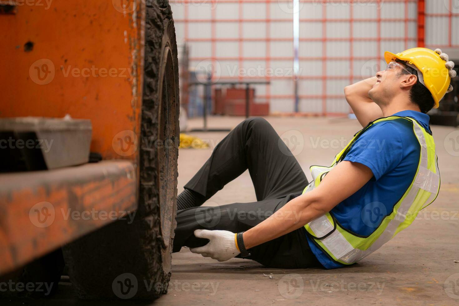 Young man working in a steel industry factory. He was critically hurt when a forklift ran over his leg and had to be transported to the hospital. photo