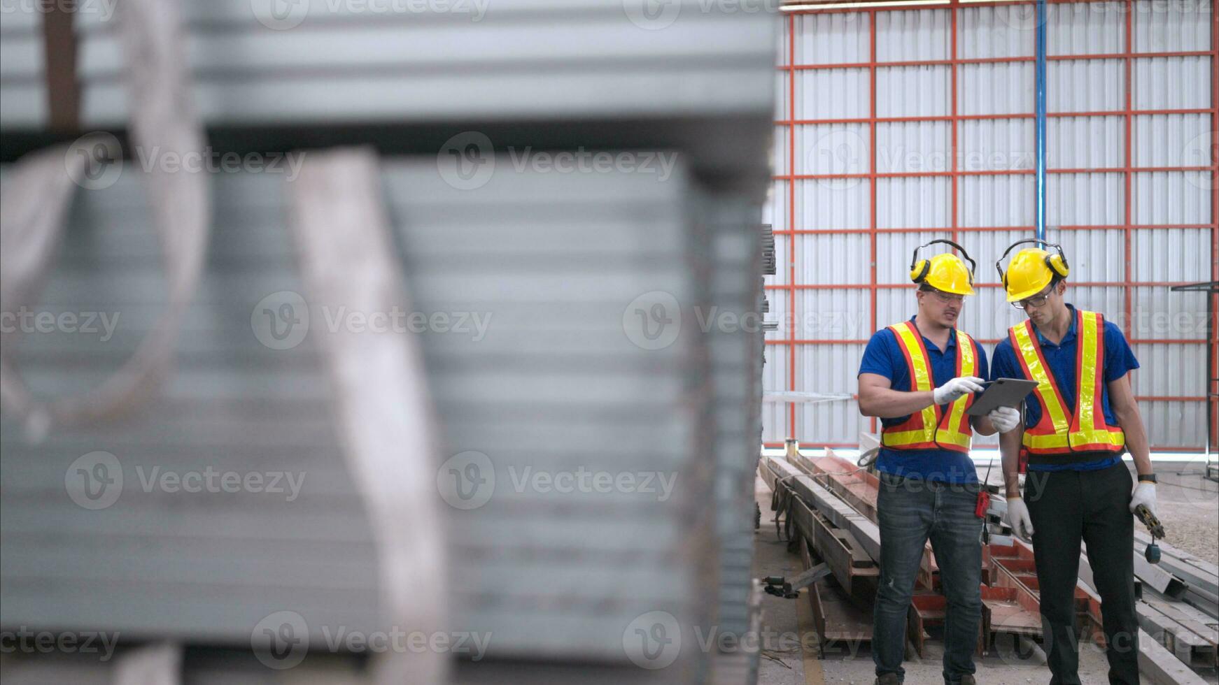 Warehouse workers in hard hats and helmets, Inspect and count steel in