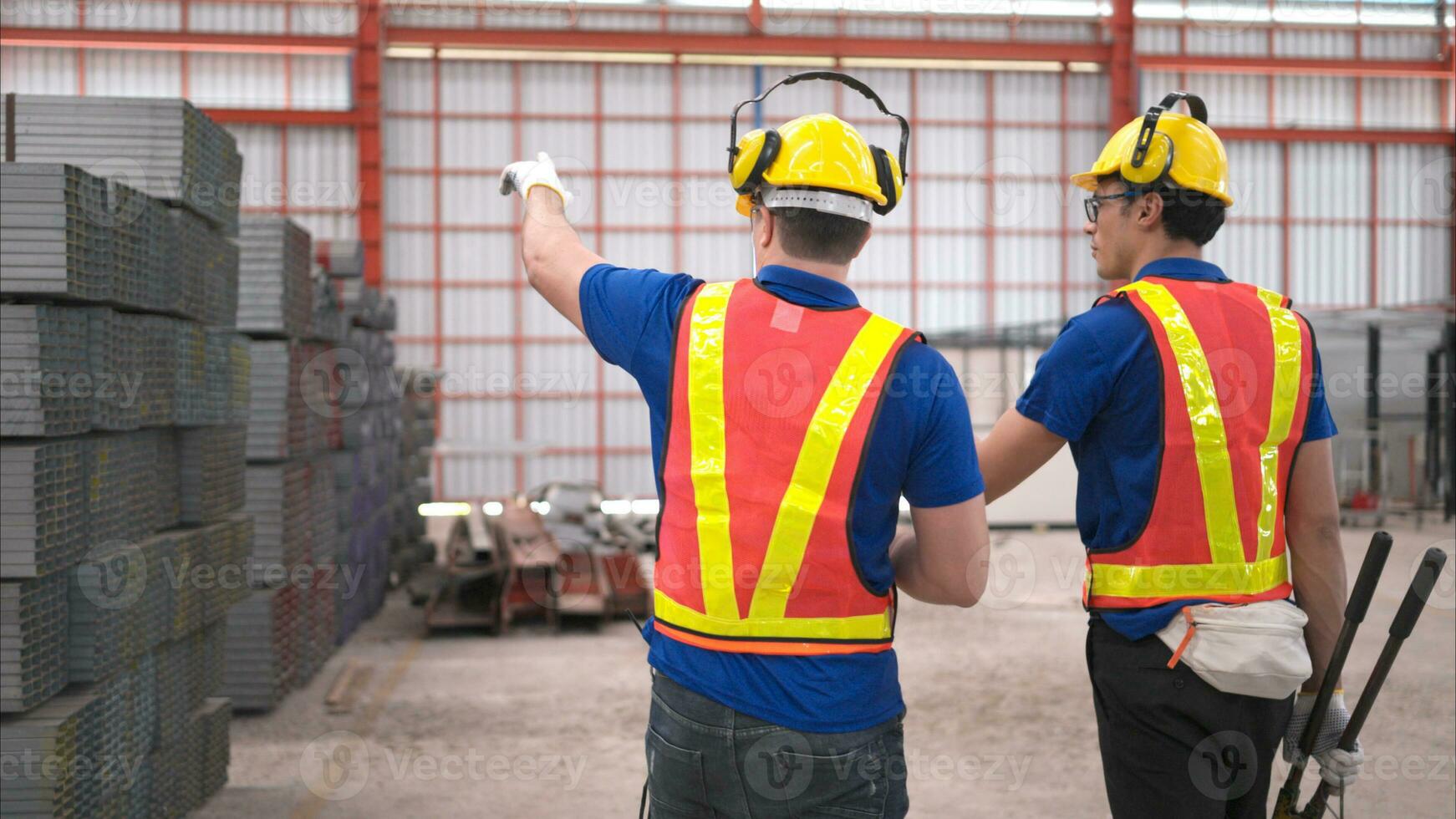 Warehouse workers in hard hats and helmets, Inspect and count steel in the warehouse. photo