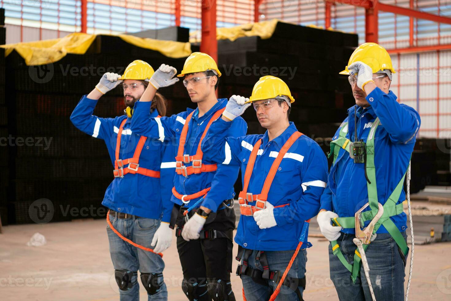 Portrait of a team of industrial workers standing together in a warehouse photo